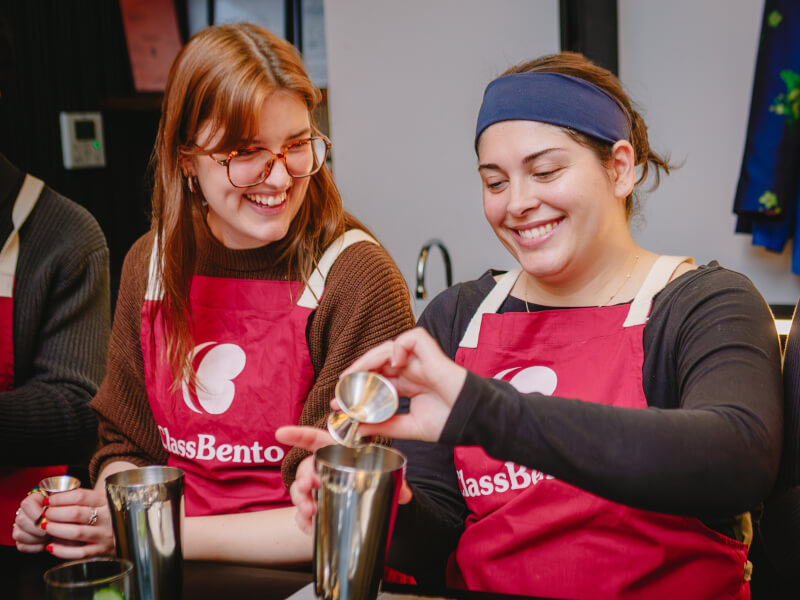 Women making cocktails together